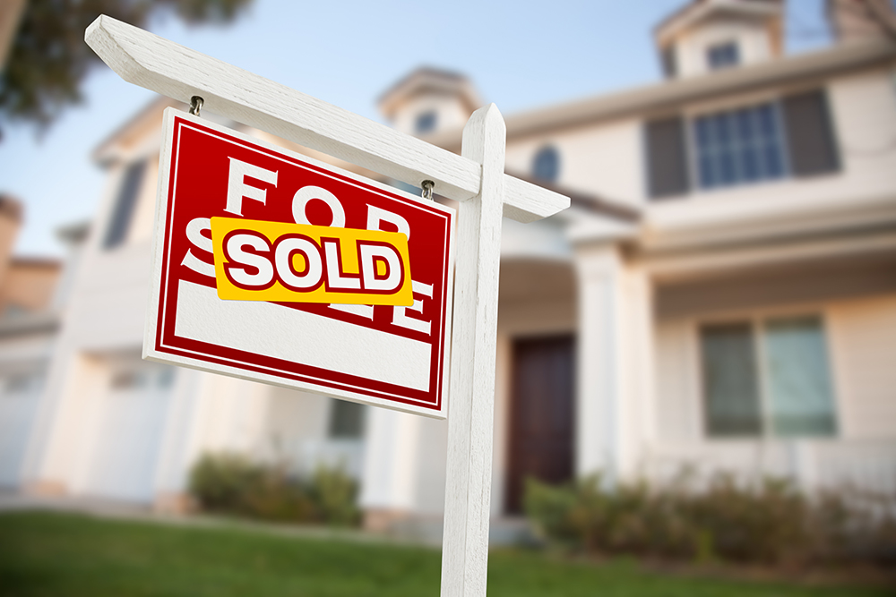 Home For Sale Real Estate Sign in Front of New House.